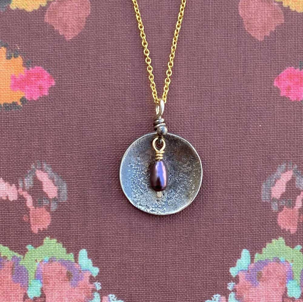 Necklace with a pendant on a floral patterned background