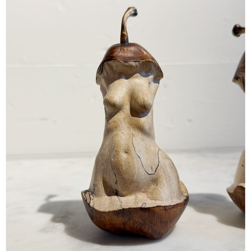 Wooden sculpture of a nude figure on a white background by Joe Lupiani