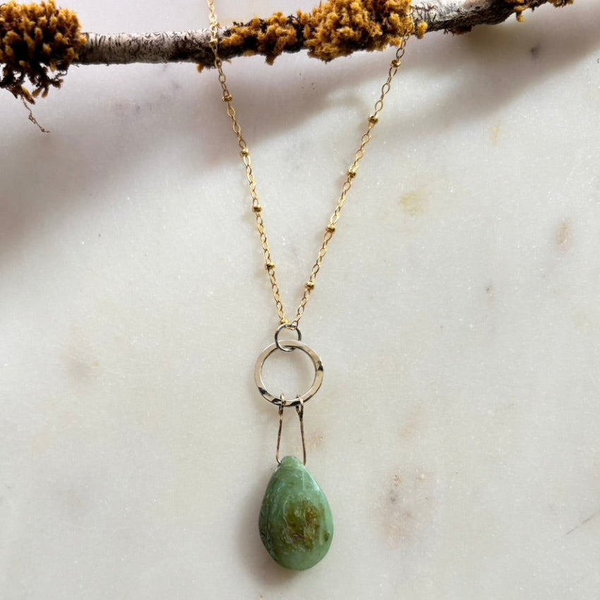 Necklace with a green teardrop pendant 