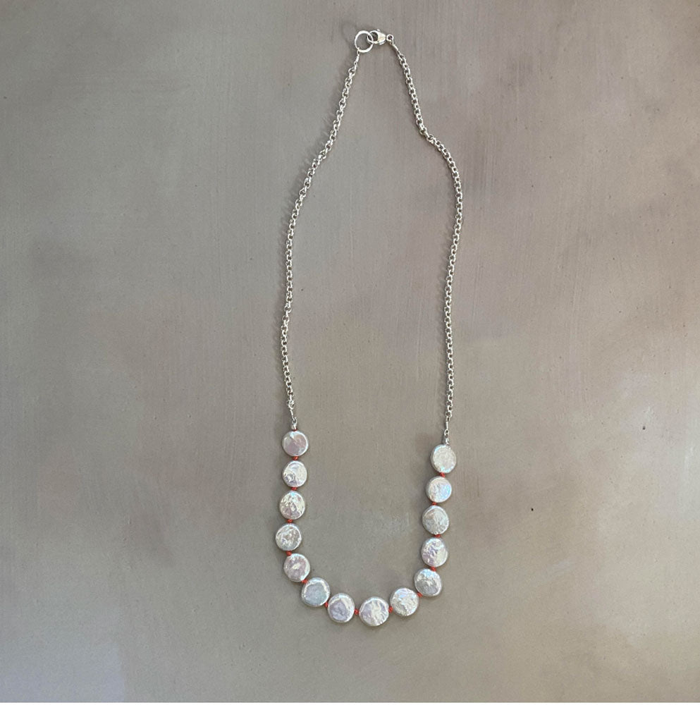 Pearl necklace on a gray background