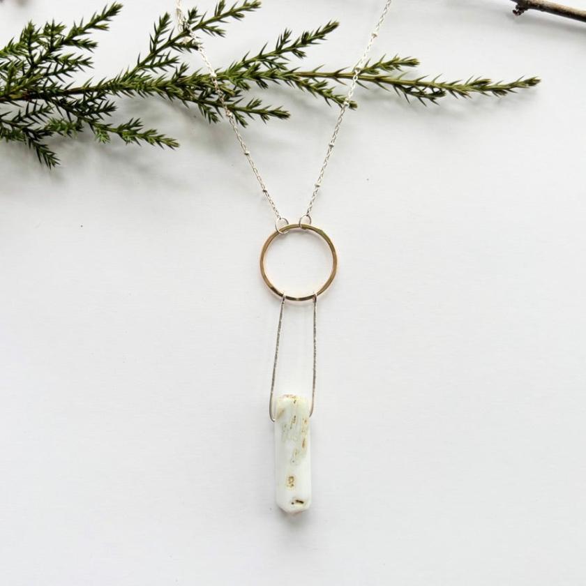  the Solstice Necklace blends a gold hammered circle with sterling silver and a stunning dendrite opal