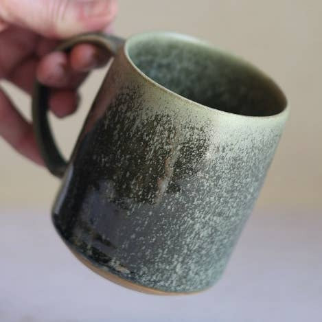 Gravesco Pottery moss green handmade stoneware mug held in hand, detail view