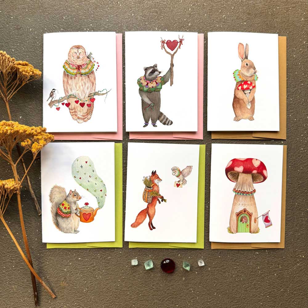 Set of six greeting cards with animal illustrations on a textured surface.