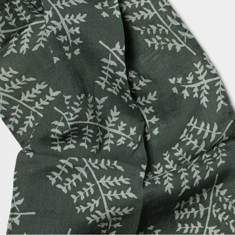 Dark green fabric with white leaf pattern