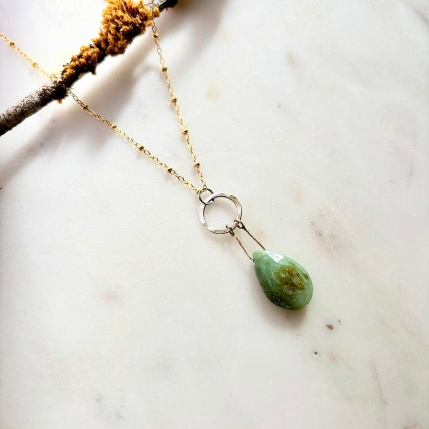 Necklace with a green teardrop pendant 