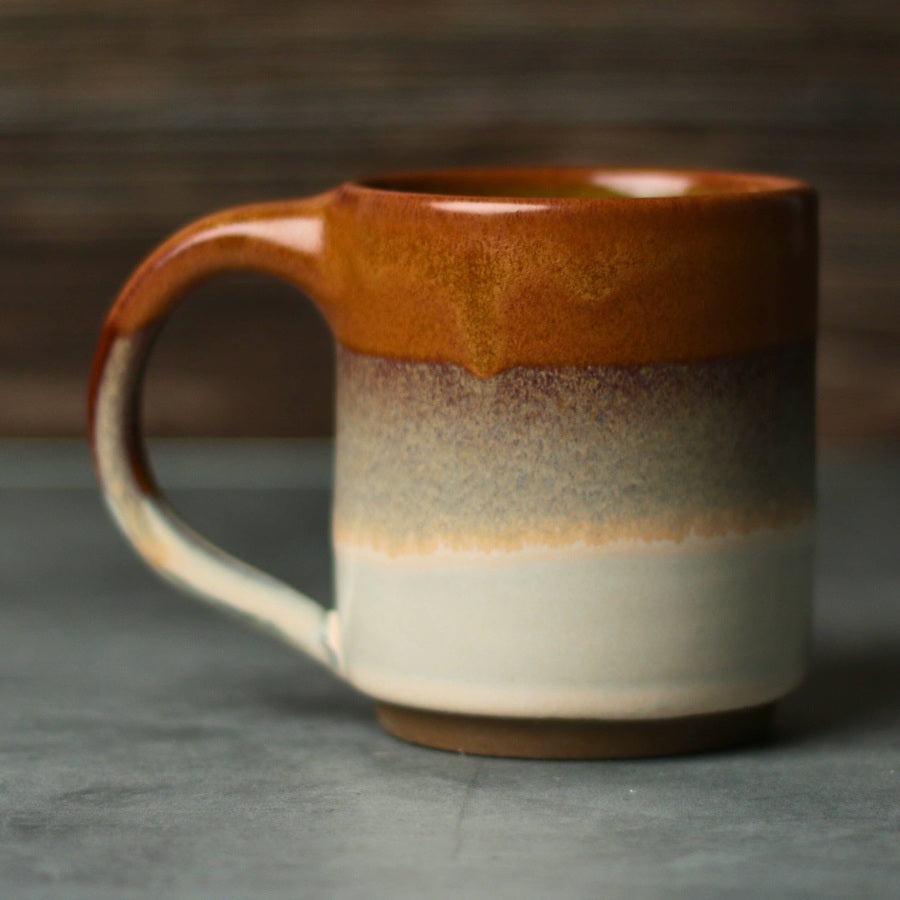 Jordan-Jean Ceramics Sienna handmade ceramic mug with rust and cream reactive glaze, side view