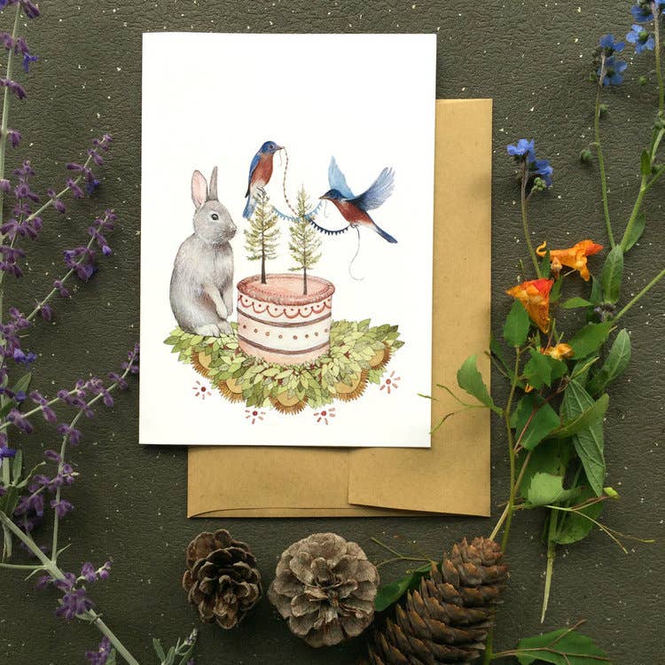 Polanshek of the Hills Celebrate illustrated greeting card close-up showing rabbit, bluebirds, and pine tree birthday cake detail