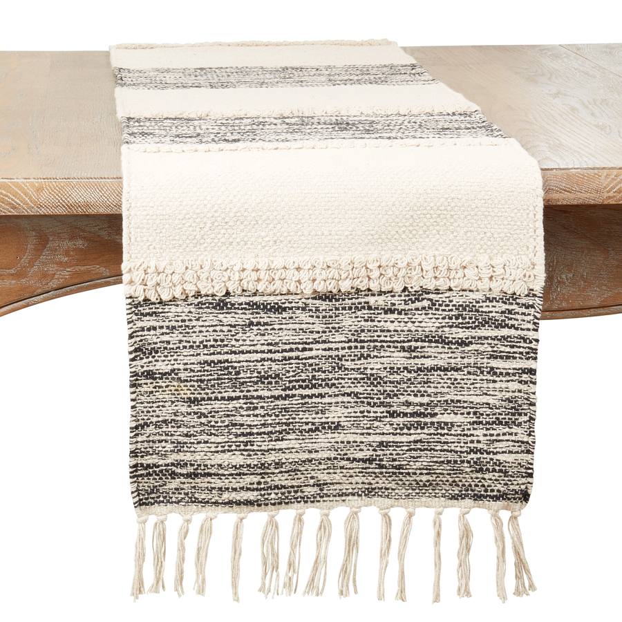 Saro Lifestyle Banded cotton table runner in black and natural with fringed edges, folded corner detail