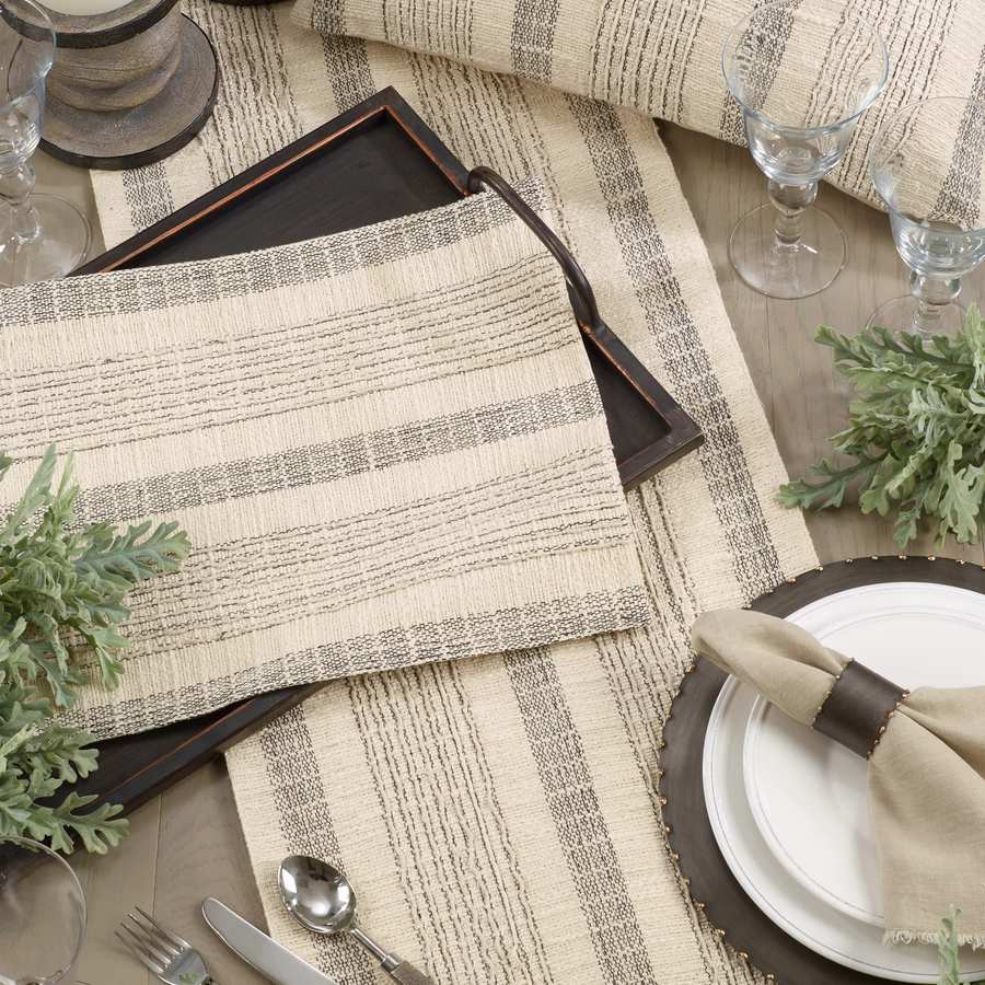 Saro Lifestyle textured striped ivory cotton table runner styled with pillow and place setting