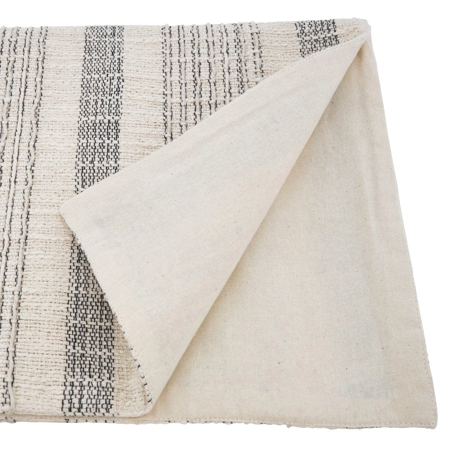 Saro Lifestyle textured striped ivory cotton table runner, folded corner showing woven texture