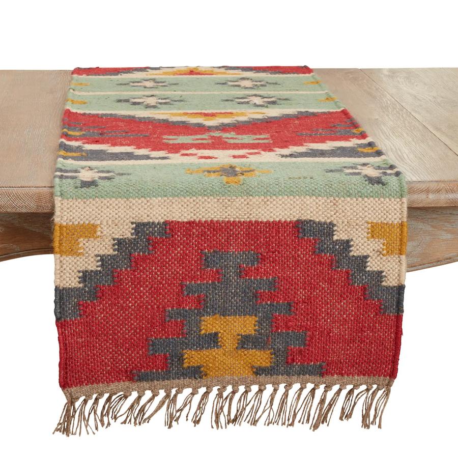 Saro Lifestyle Tribal Tapestry kilim table runner draped on wood table showing southwestern pattern