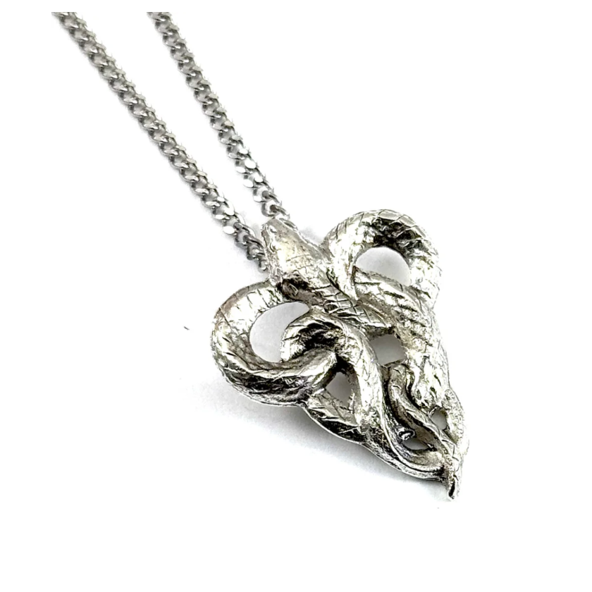 Silver leaf-shaped pendant on a chain against a white background