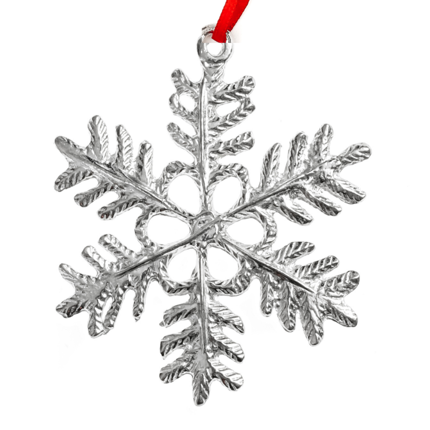Silver snowflake ornament with a red ribbon on a white background