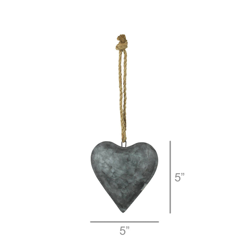 Heart-shaped metal ornament with rope on a white background