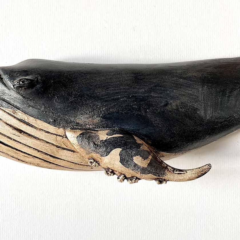 Carved wooden whale wall plaques by Wendy Lichtensteiger 